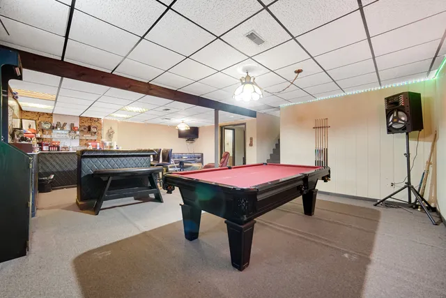 a room with furniture and pool table