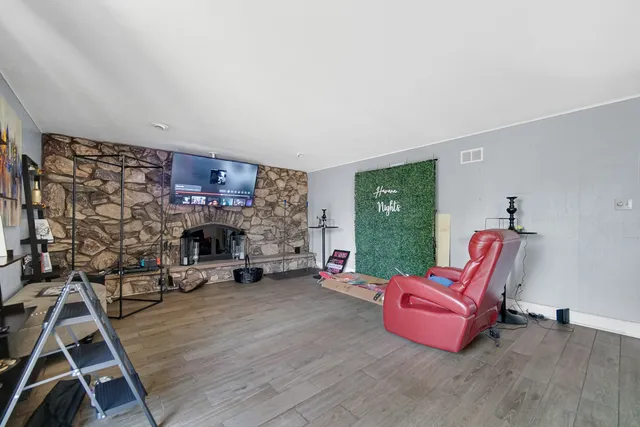a living room with furniture a fireplace and a table