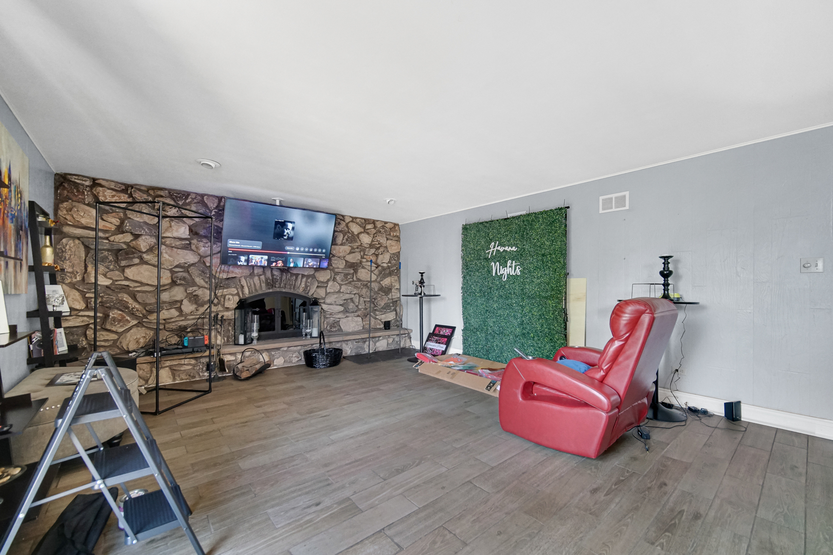 18443 Maple Street Lansing, IL 60438 - Photo 7 of 20 a living room with furniture a fireplace and a table