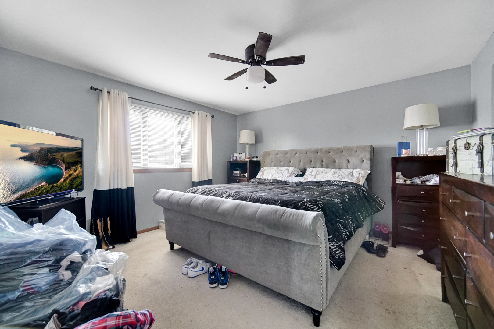 18443 Maple Street Lansing, IL 60438 - Photo 8 of 20 a bedroom with a bed and a flat screen tv