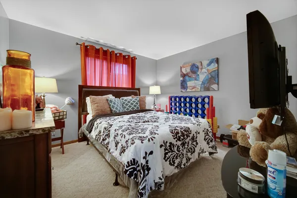 a bed room with a bed and a television