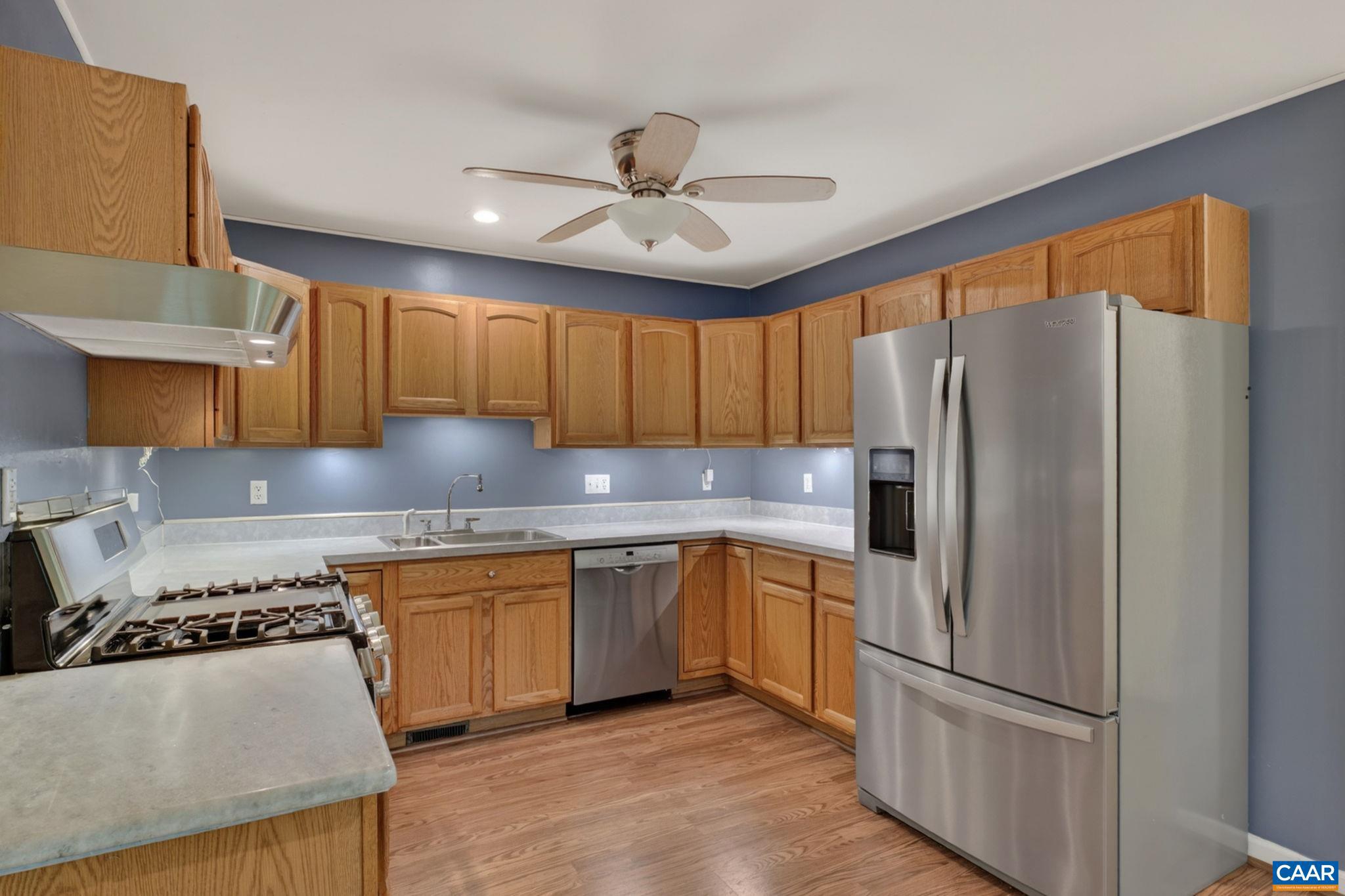 37 Laguna Road Palmyra, VA 22963 - Photo 16 of 44 a kitchen with stainless steel appliances granite countertop a refrigerator a sink dishwasher a stove and white countertops with wooden floor
