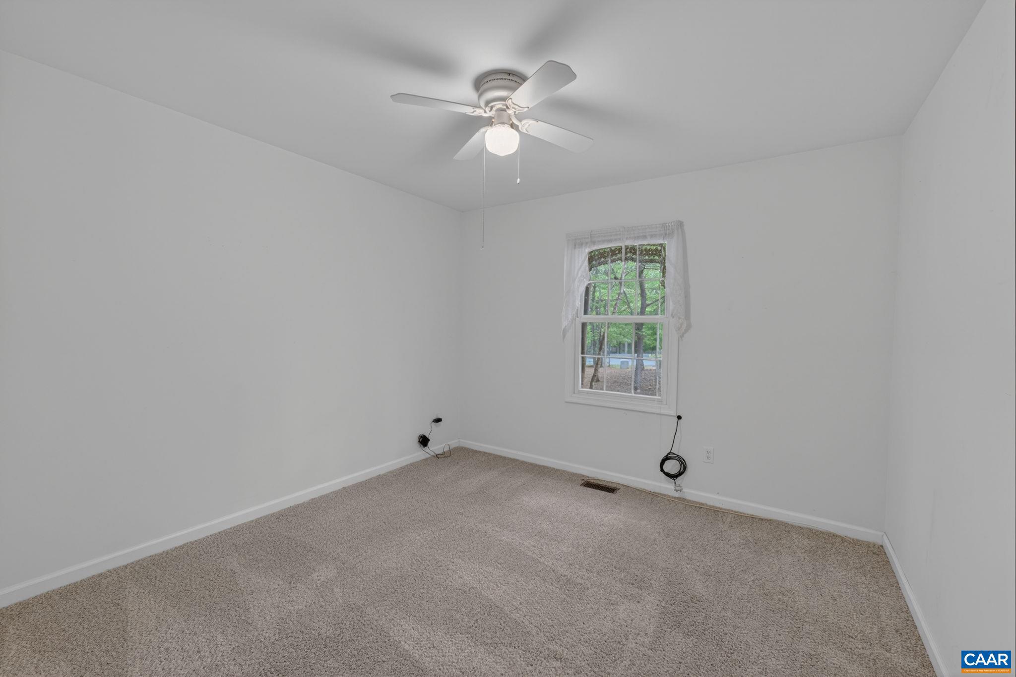 37 Laguna Road Palmyra, VA 22963 - Photo 35 of 44 an empty room with a window and a fan