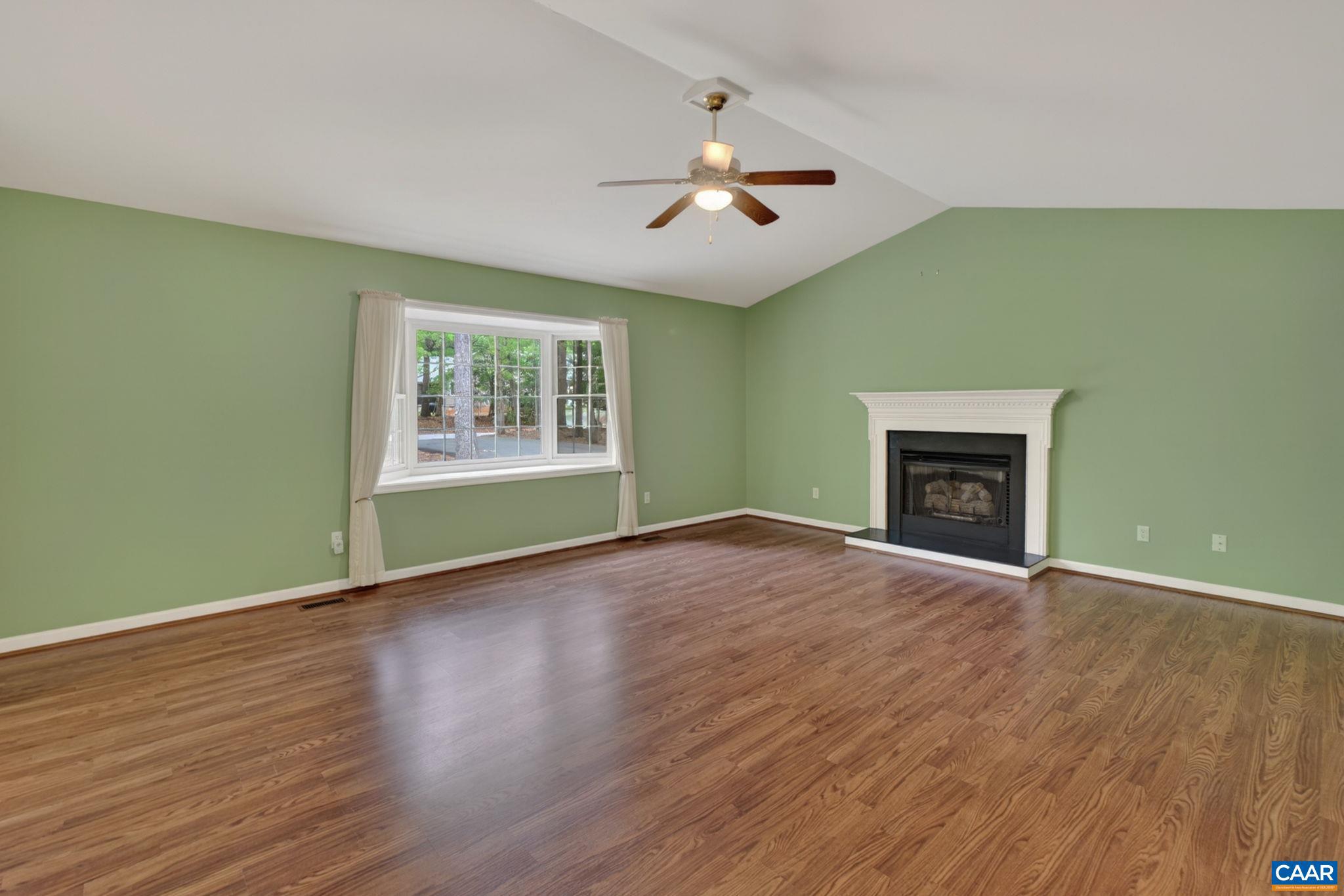 37 Laguna Road Palmyra, VA 22963 - Photo 9 of 44 an empty room with wooden floor fireplace and window