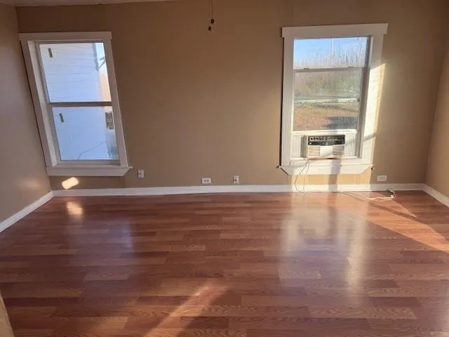a view of room with window and wooden floor