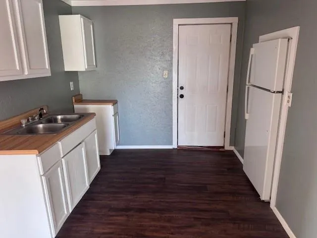 a kitchen with a sink a refrigerator and a stove