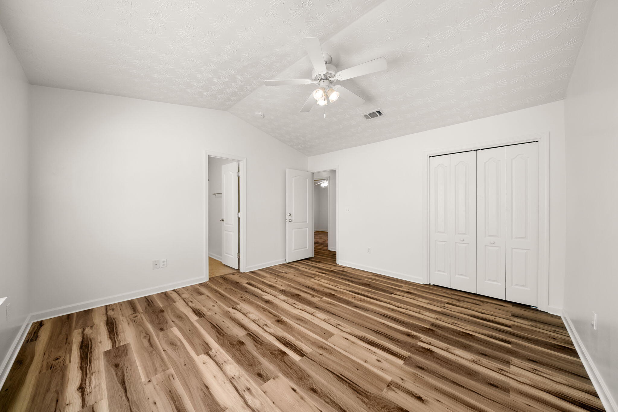 88 Tropical Way Freeport, FL 32439 - Photo 13 of 31 a view of a bedroom with wooden floor and fan