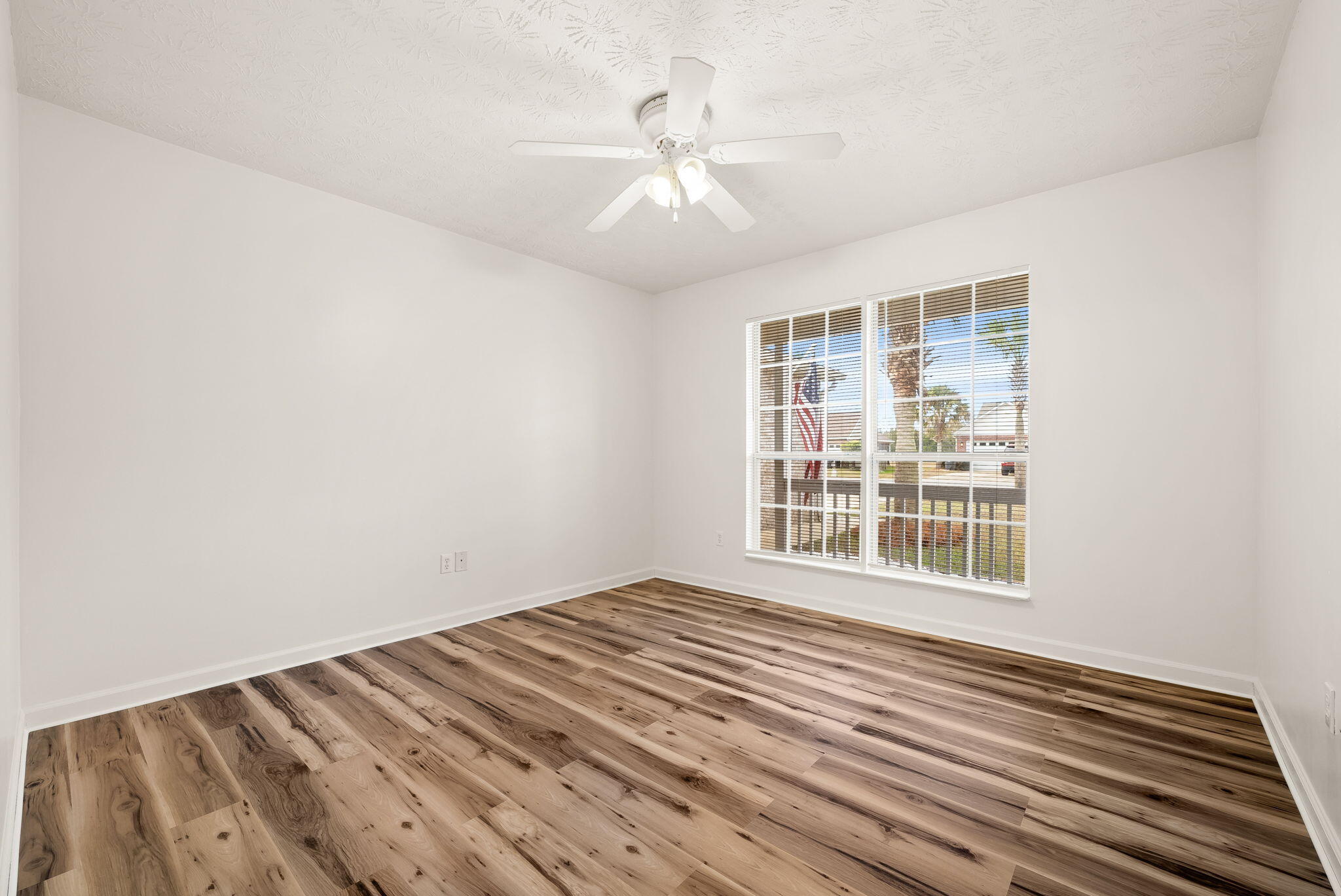 88 Tropical Way Freeport, FL 32439 - Photo 16 of 31 a view of an empty room with wooden floor and a window