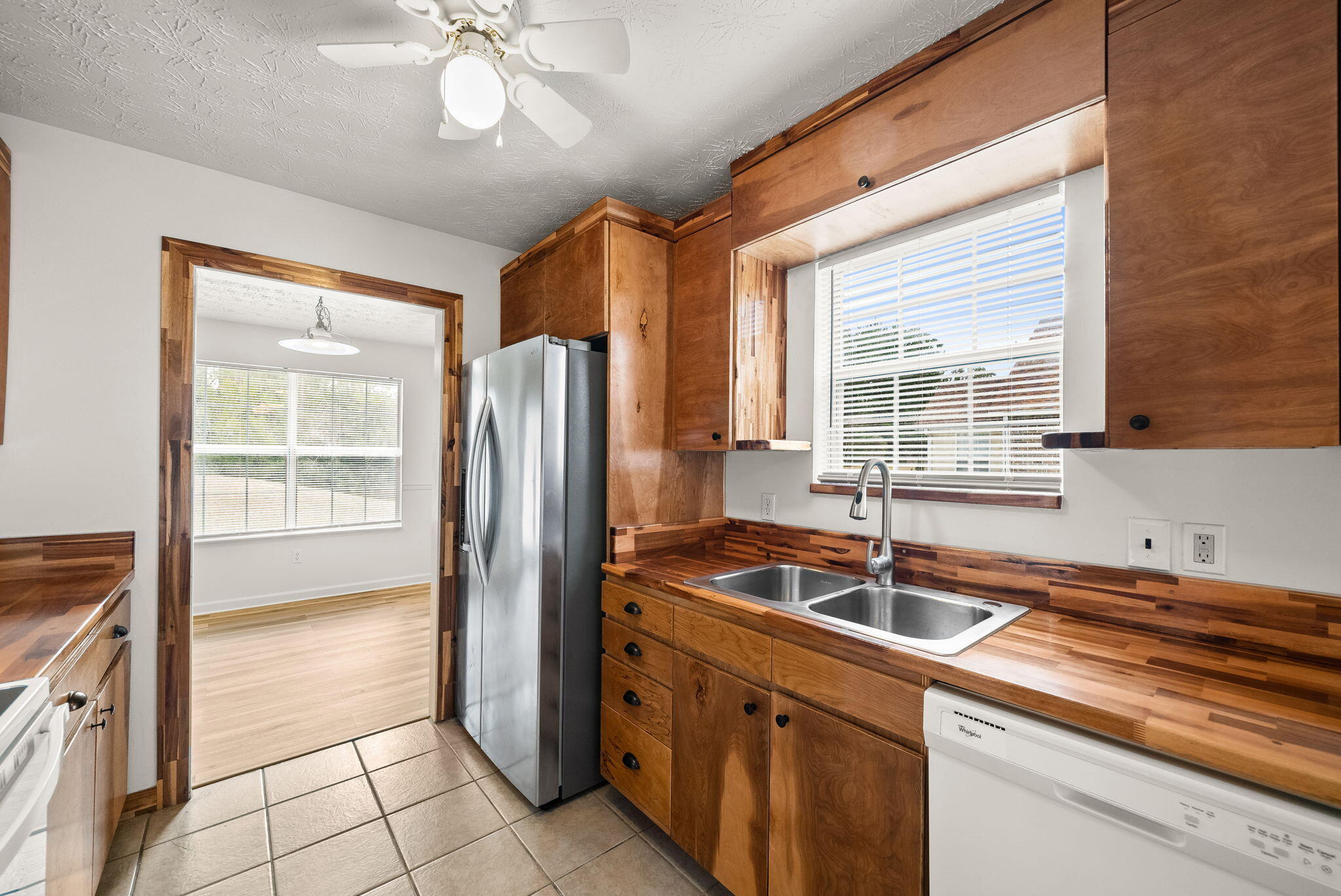 88 Tropical Way Freeport, FL 32439 - Photo 5 of 31 a kitchen with stainless steel appliances granite countertop a sink and a refrigerator
