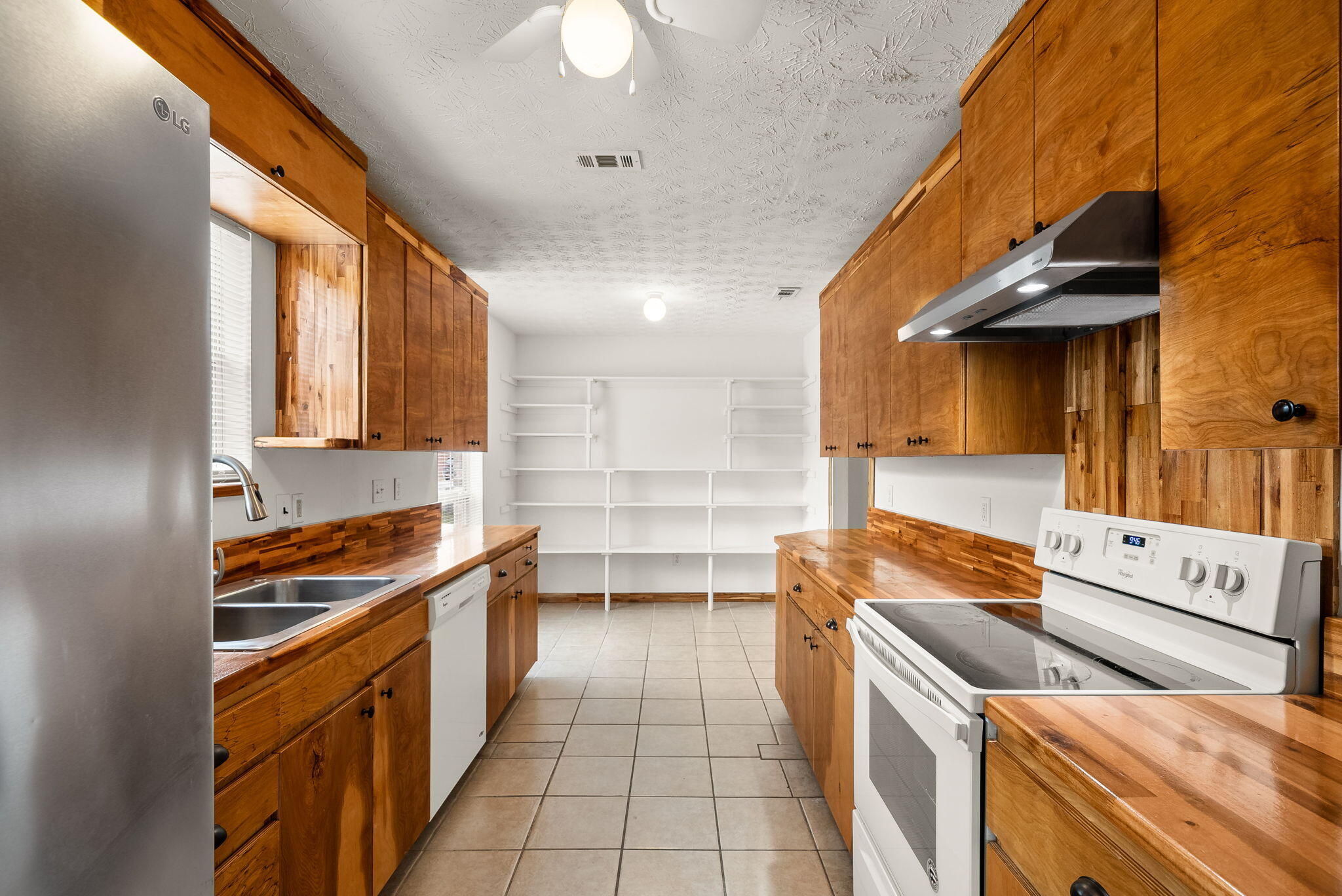 88 Tropical Way Freeport, FL 32439 - Photo 6 of 31 a kitchen with stainless steel appliances granite countertop a stove a sink and a microwave