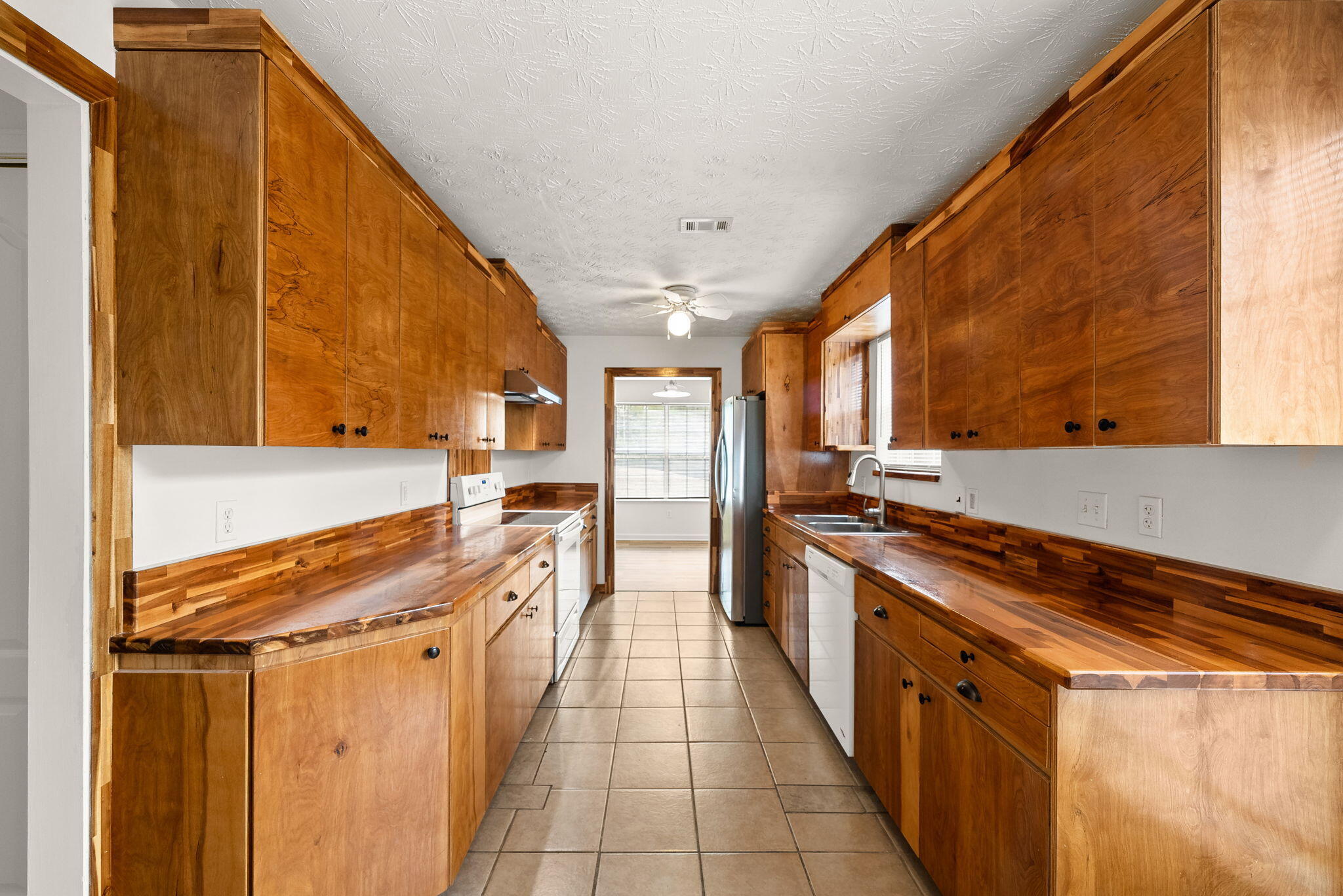88 Tropical Way Freeport, FL 32439 - Photo 8 of 31 a kitchen with stainless steel appliances a sink and cabinets