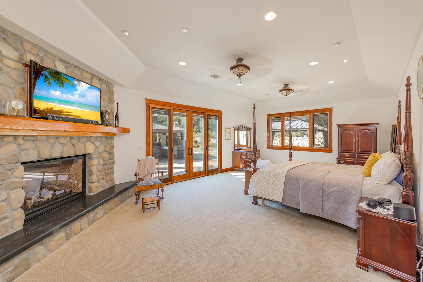 705 South Rice Road Ojai, CA 93023 - Photo 21 of 61 a spacious bedroom with a bed and a fireplace