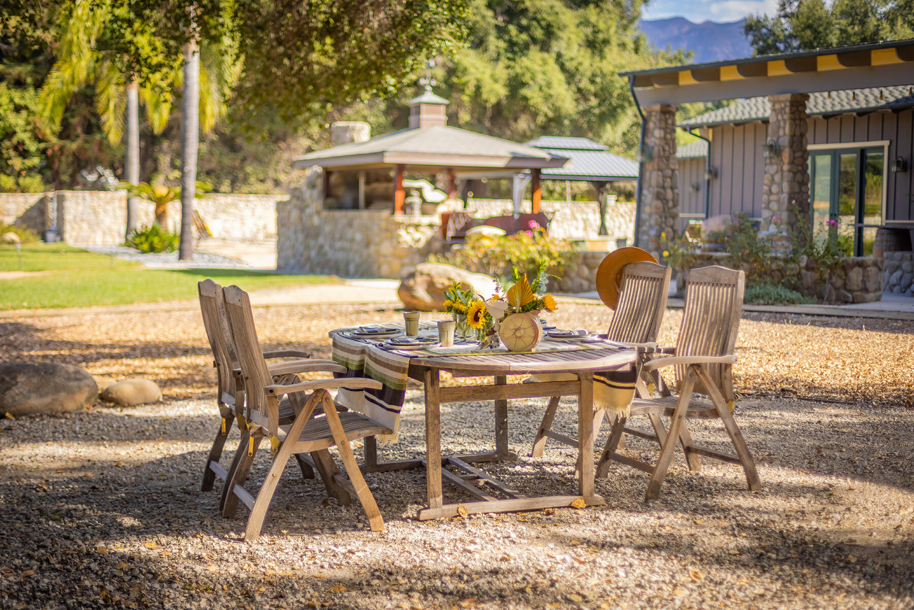 705 South Rice Road Ojai, CA 93023 - Photo 38 of 61 a view of a patio with table and chairs near a yard