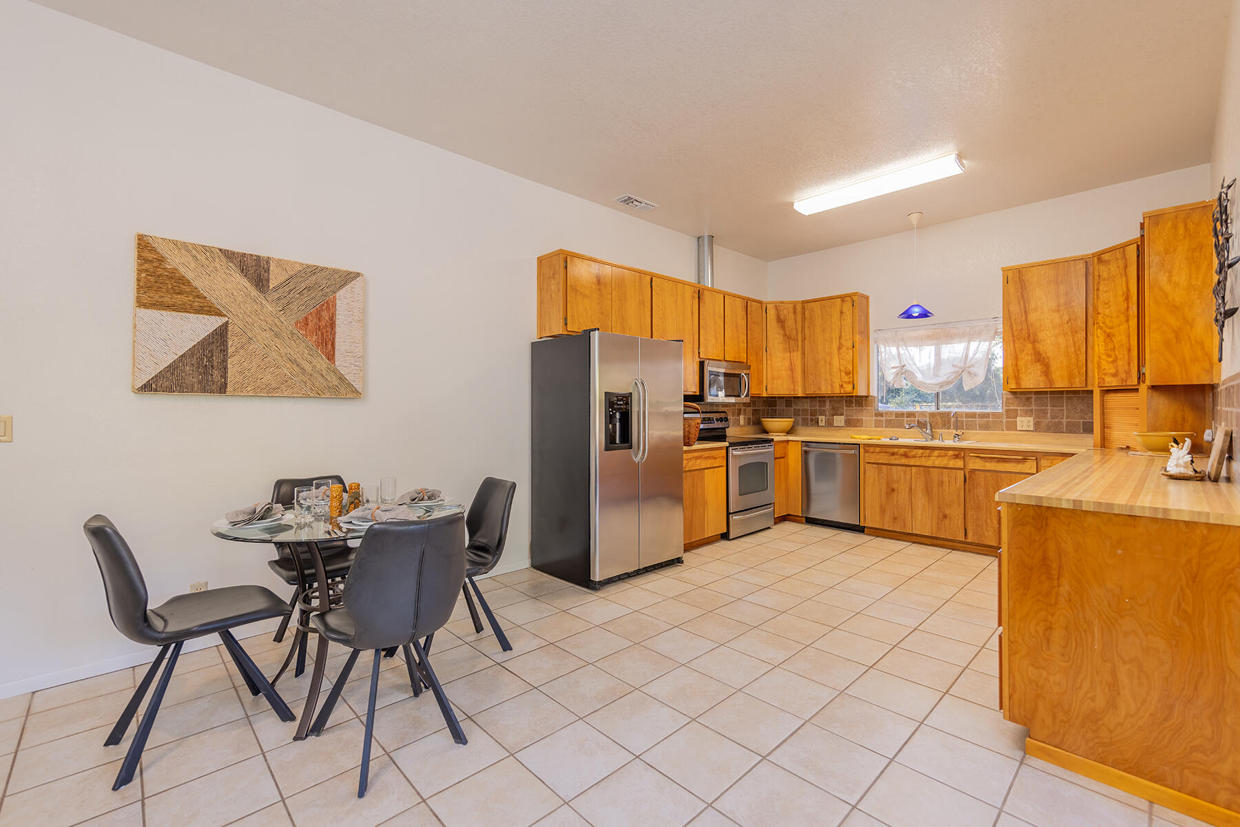 705 South Rice Road Ojai, CA 93023 - Photo 47 of 61 a kitchen with stainless steel appliances a stove a sink cabinets and a dining table