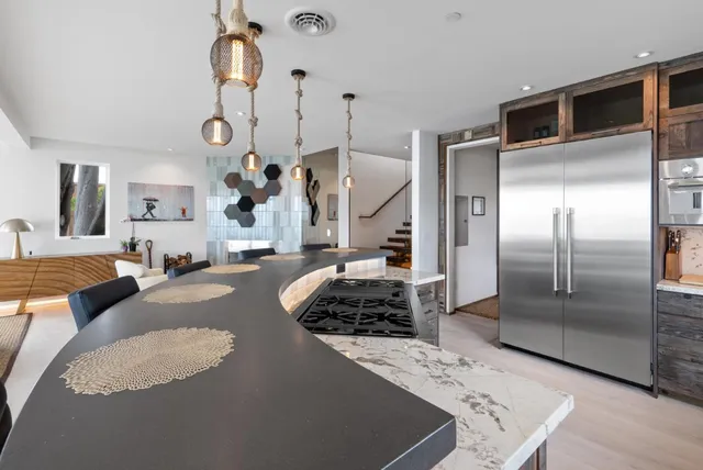 a front view of a house with a yard balcony and outdoor seating