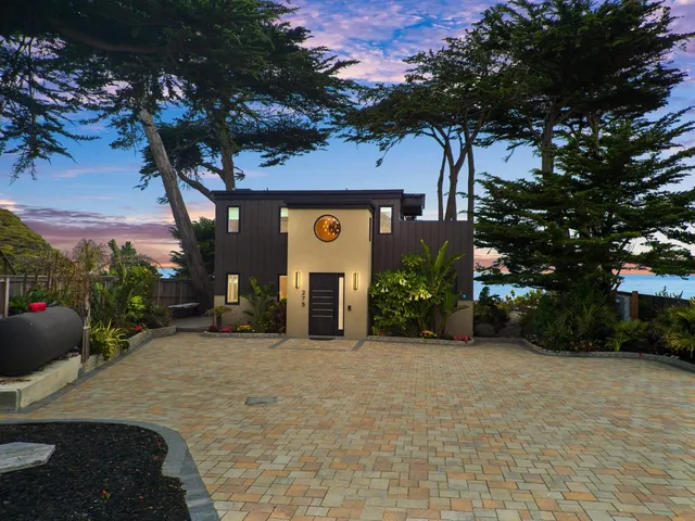 a front view of a house with a yard garage and outdoor seating