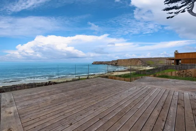 a view of a balcony with wooden floor and outdoor space