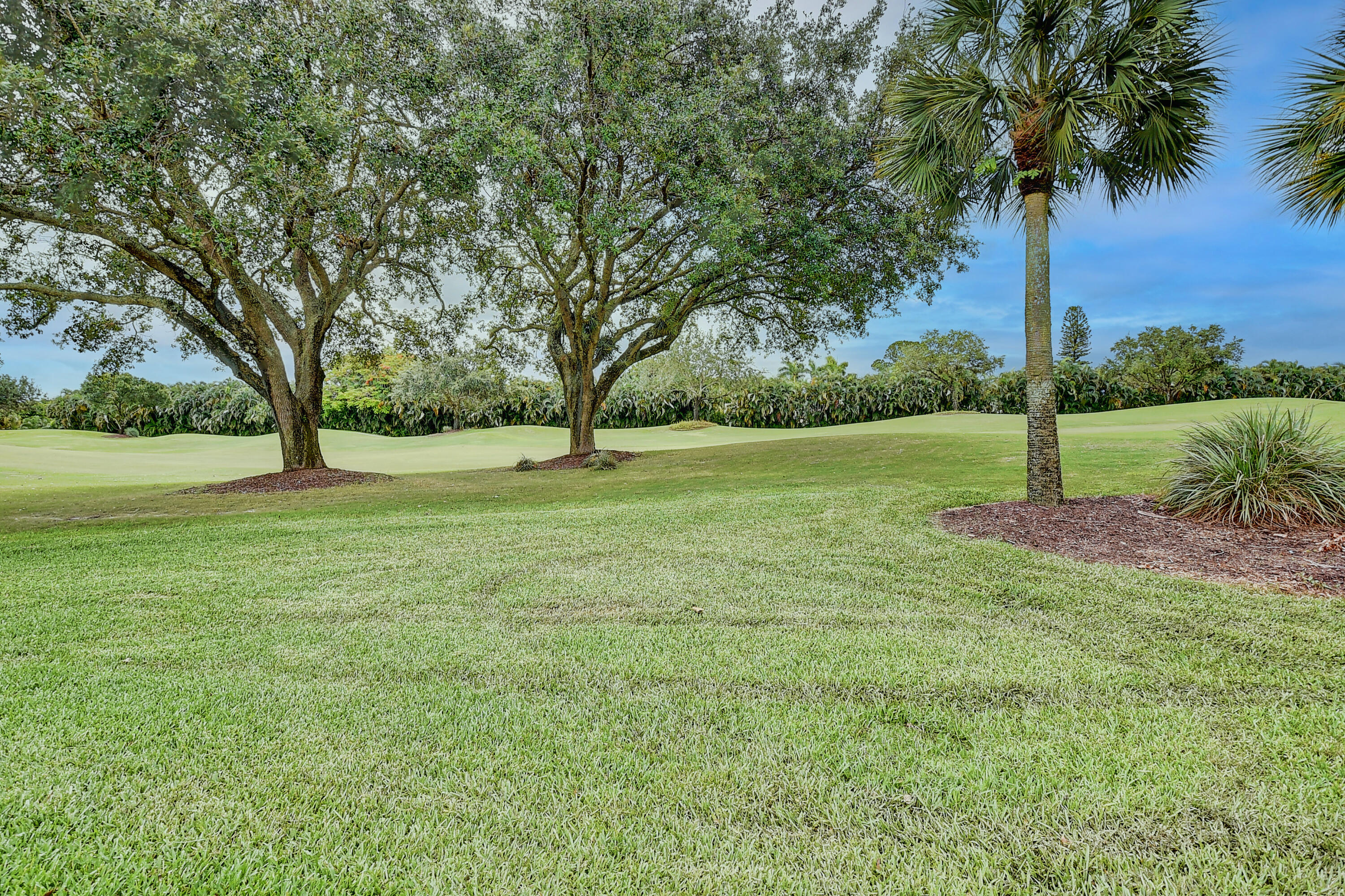 19550 Sawgrass Drive, Unit 2102 Boca Raton, FL 33434 - Photo 26 of 76 a view of a field with a tree