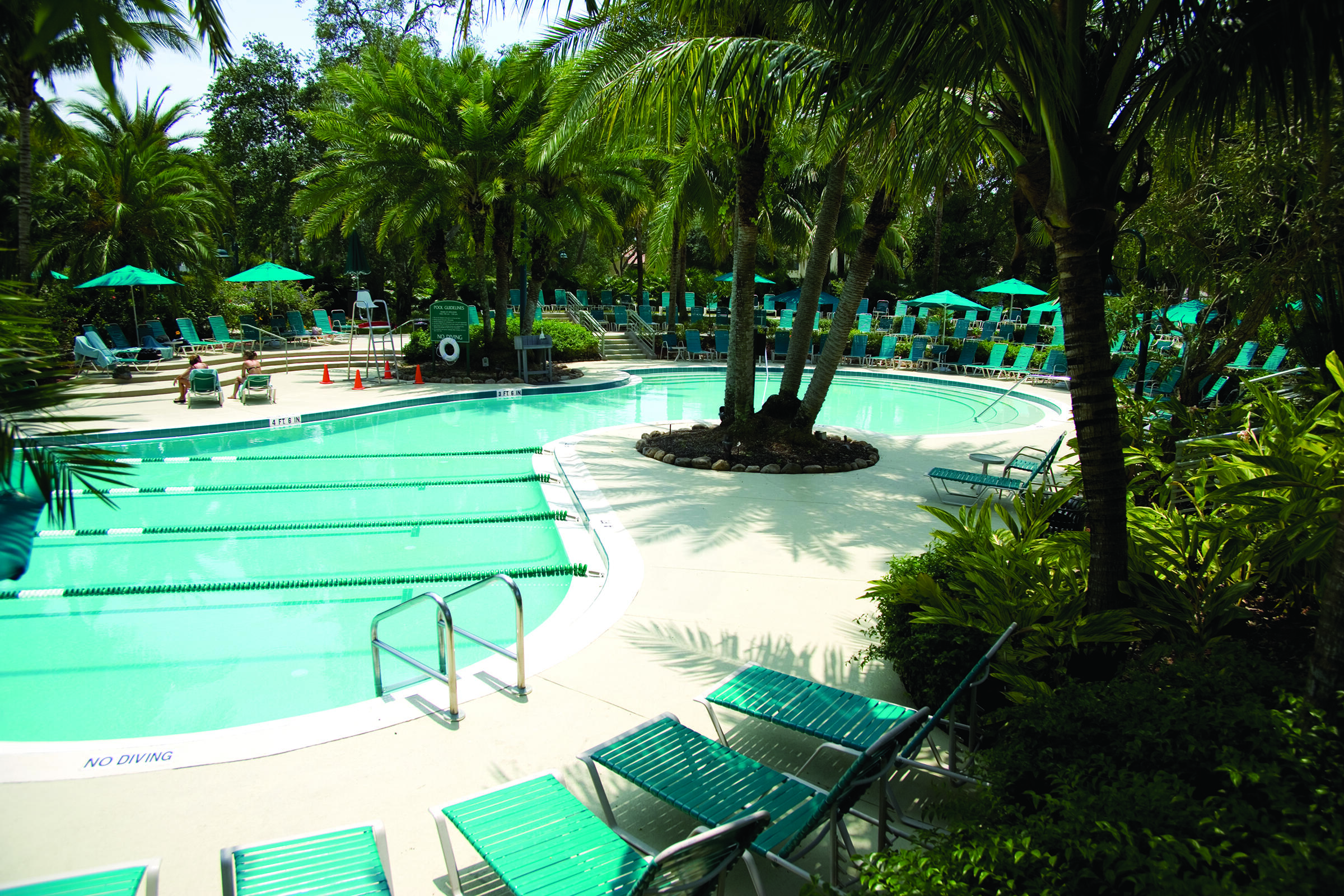 19550 Sawgrass Drive, Unit 2102 Boca Raton, FL 33434 - Photo 64 of 76 a swimming pool with outdoor seating and trees
