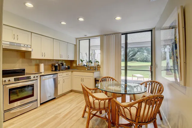 a kitchen with refrigerator a stove and cabinets