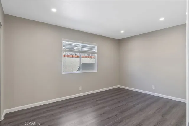 a room with wooden floor and natural light