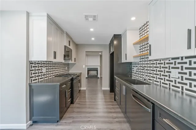 a kitchen with stainless steel appliances granite countertop a stove and a sink