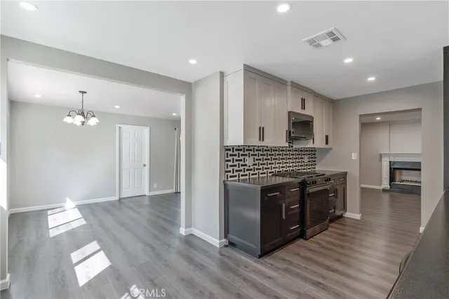a kitchen with stainless steel appliances granite countertop a stove top oven and sink