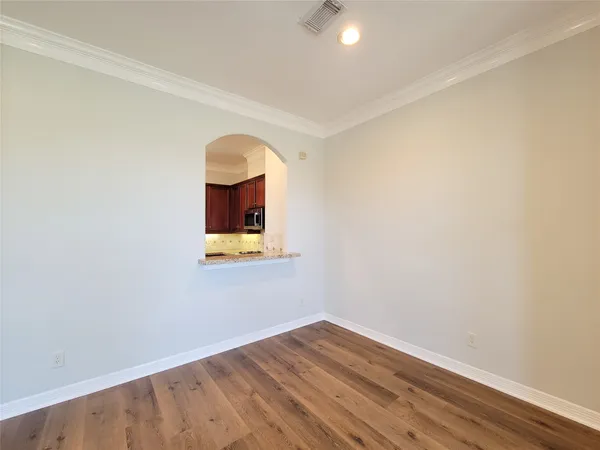 a view of a small space with wooden floor and a window