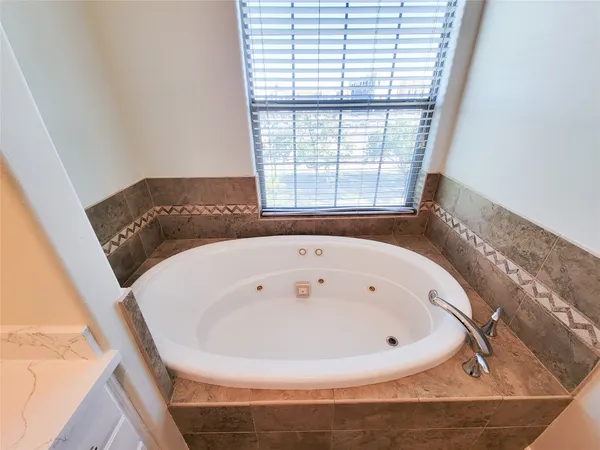 a bathroom with a bathtub and a window