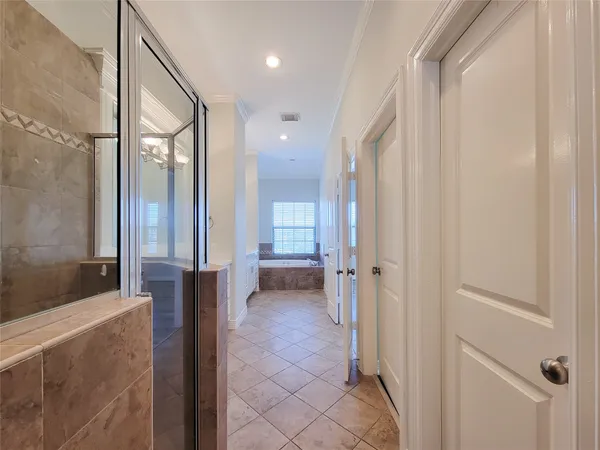 a bathroom with a glass shower door a bathtub a sink and a mirror