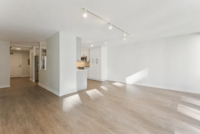 a view of a kitchen with a sink and a refrigerator