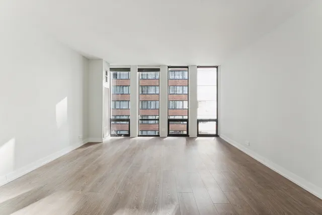 an empty room with wooden floor and closet