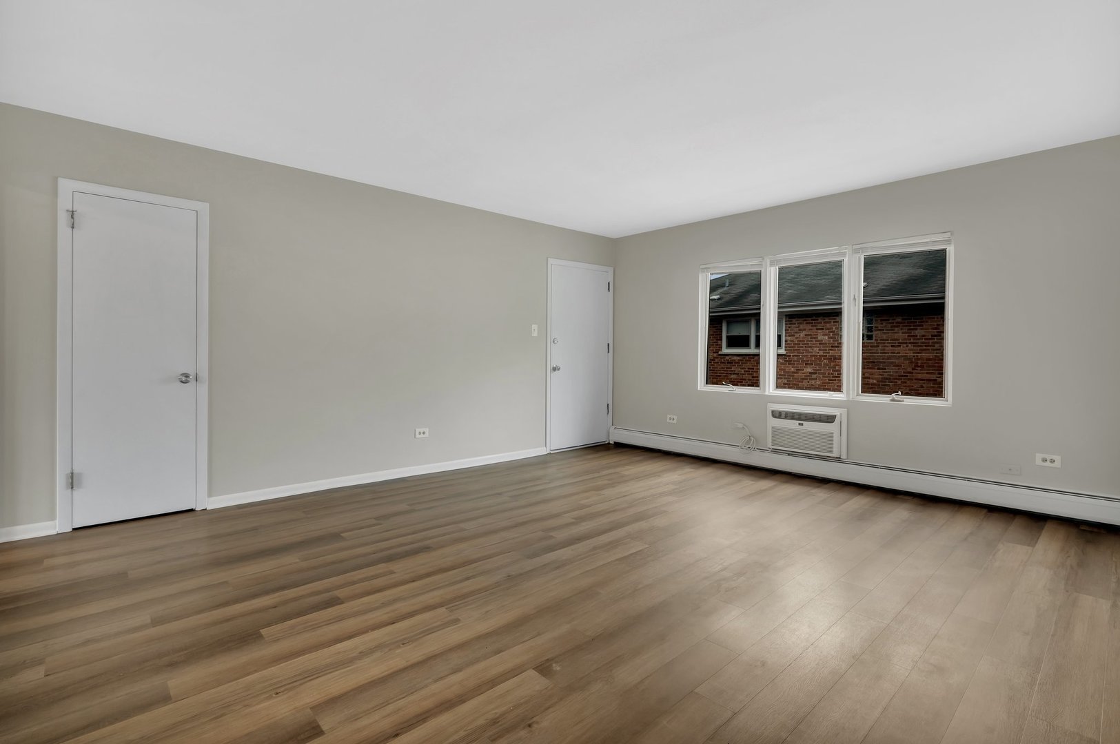 42 South Waiola Avenue, Unit 2 La Grange, IL 60525 - Photo 6 of 13 a view of a room with wooden floor and window