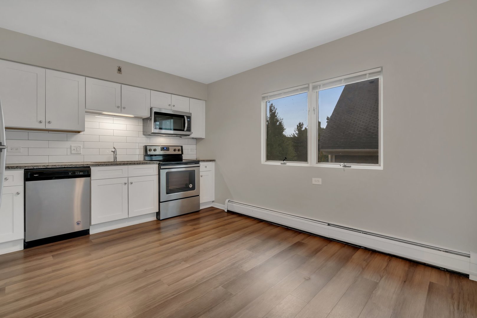 42 South Waiola Avenue, Unit 2 La Grange, IL 60525 - Photo 7 of 13 a kitchen with granite countertop white cabinets and stainless steel appliances