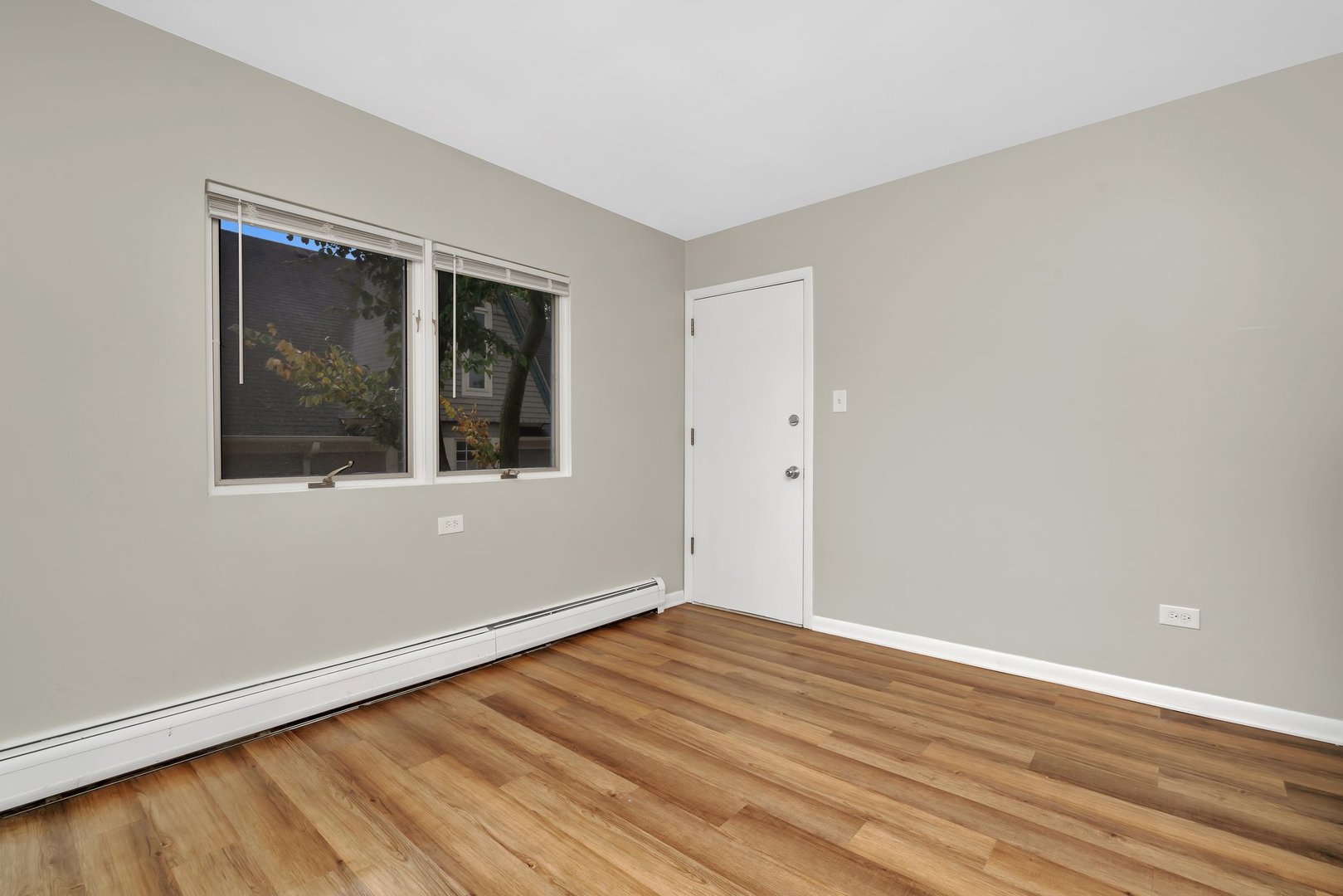 42 South Waiola Avenue, Unit 2 La Grange, IL 60525 - Photo 8 of 13 a view of an empty room with wooden floor and a window