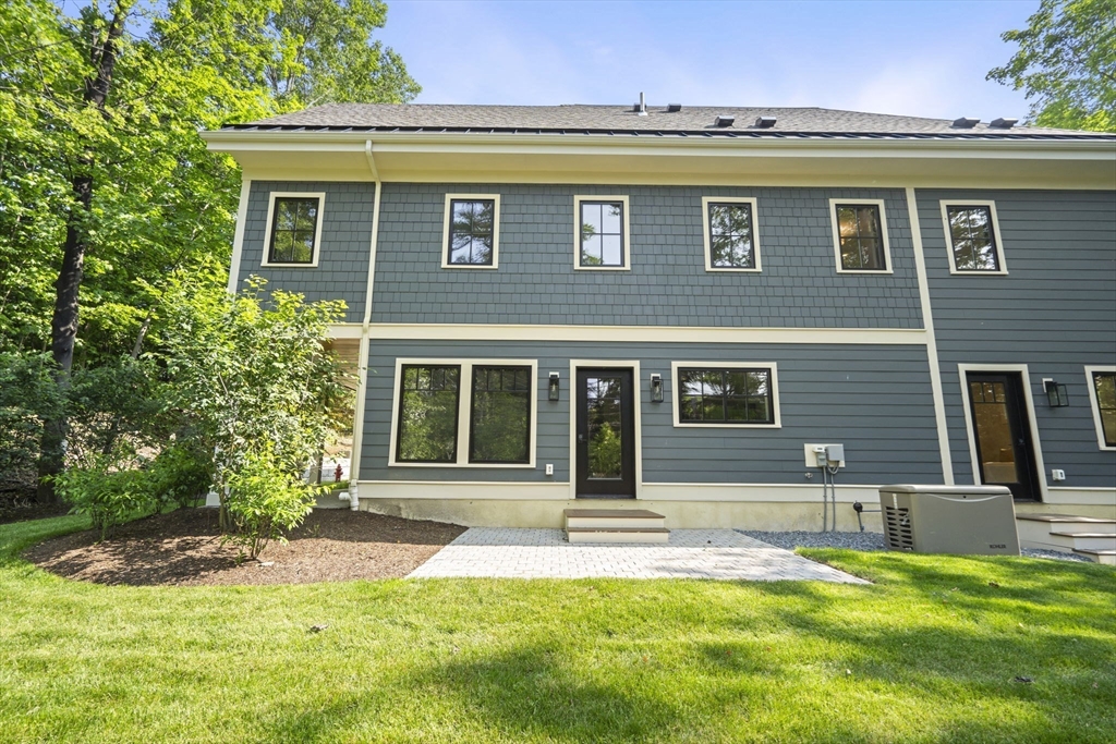 145 Warren Street, Unit 4 Newton, MA 02459 - Photo 1 of 35 a front view of a house with a yard