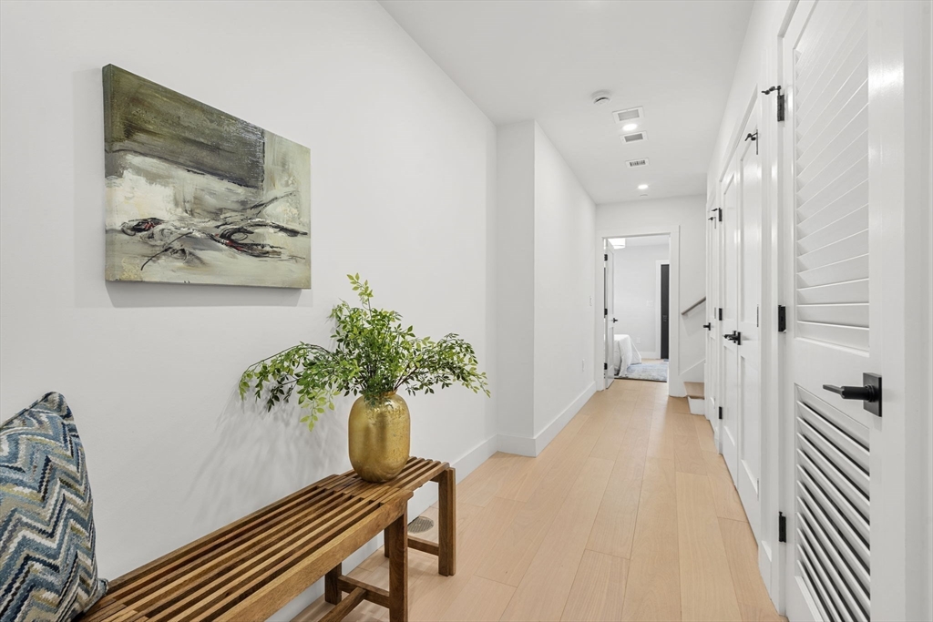 145 Warren Street, Unit 4 Newton, MA 02459 - Photo 13 of 35 a view of a hallway with paintings on the wall