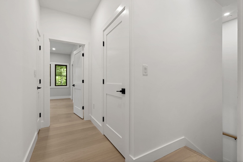 145 Warren Street, Unit 4 Newton, MA 02459 - Photo 19 of 35 a view of a hallway with wooden floor and closet
