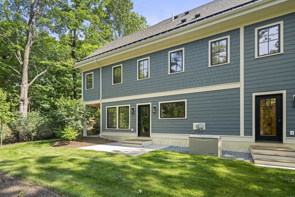 145 Warren Street, Unit 4 Newton, MA 02459 - Photo 24 of 35 a front view of a house with a yard