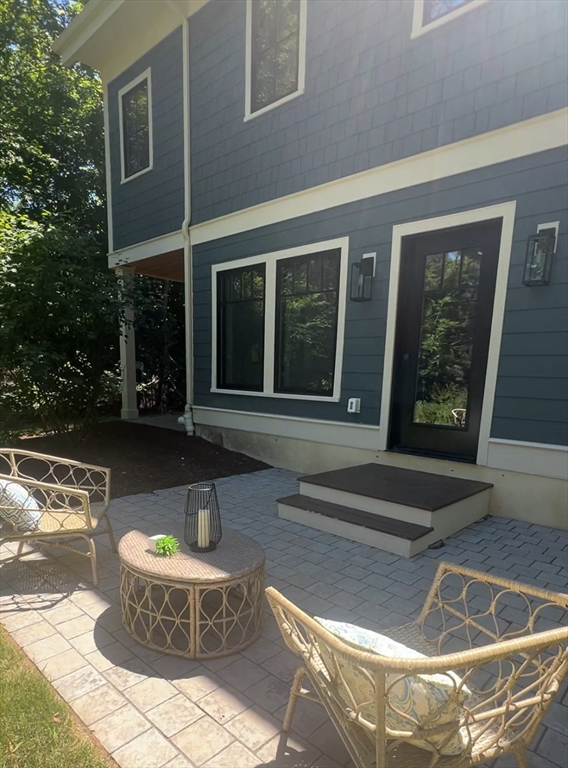 145 Warren Street, Unit 4 Newton, MA 02459 - Photo 32 of 35 a view of a house with a fountain in a patio