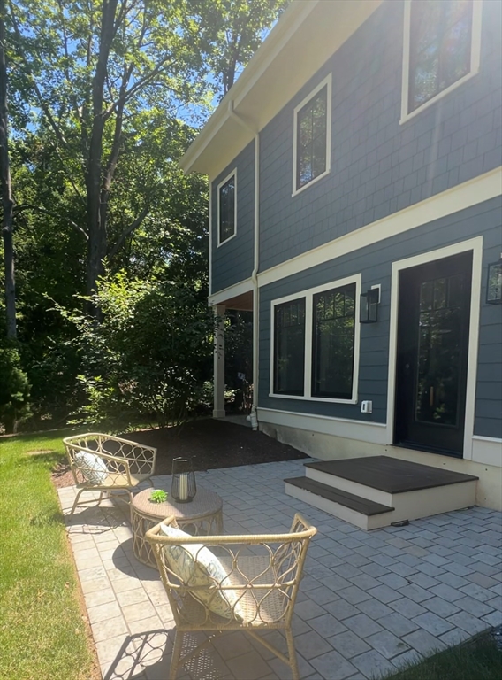 145 Warren Street, Unit 4 Newton, MA 02459 - Photo 33 of 35 a view of a house with backyard porch and sitting area