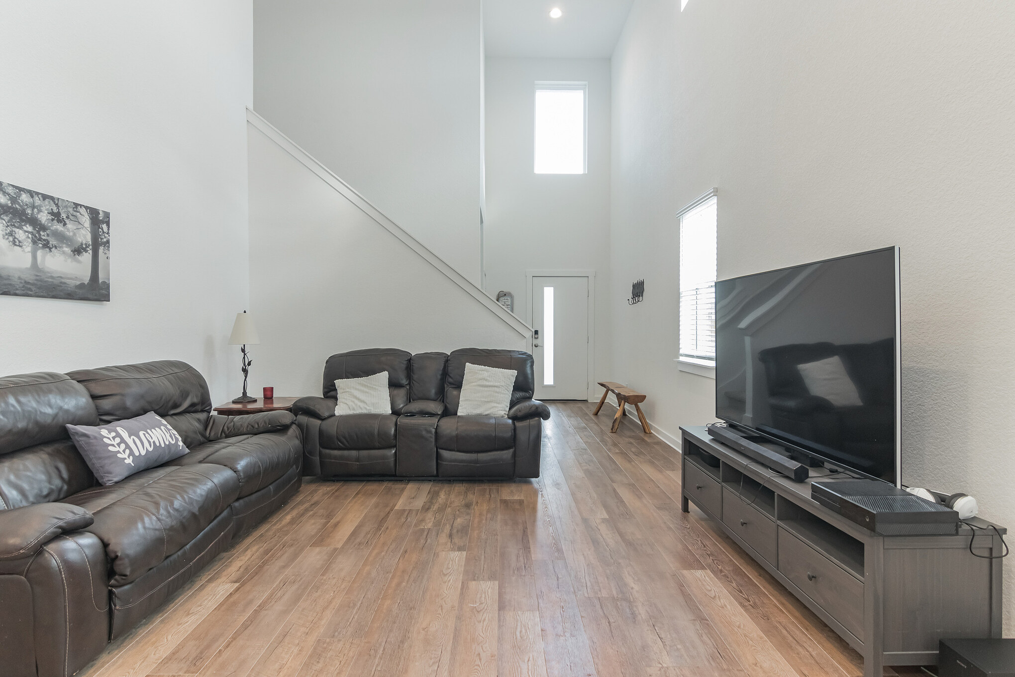 116 Century Plant Road Leander, TX 78641 - Photo 6 of 30 High ceilings and warm wood-style flooring create an inviting atmosphere in this airy main living area.