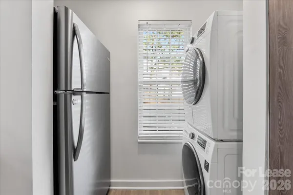 a view of walk in closet with window and refrigerator