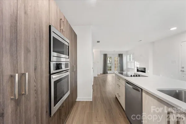 a kitchen with stainless steel appliances granite countertop a refrigerator and a sink