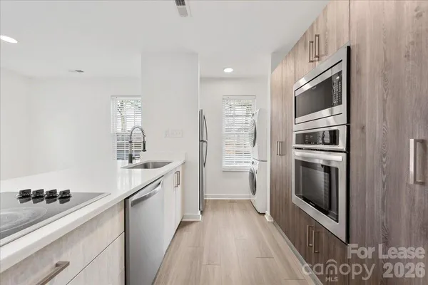 a kitchen with a sink stove and refrigerator