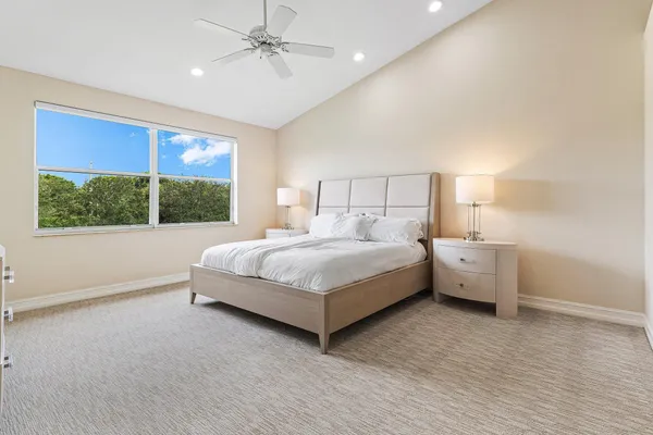 a bedroom with a large bed and a large window