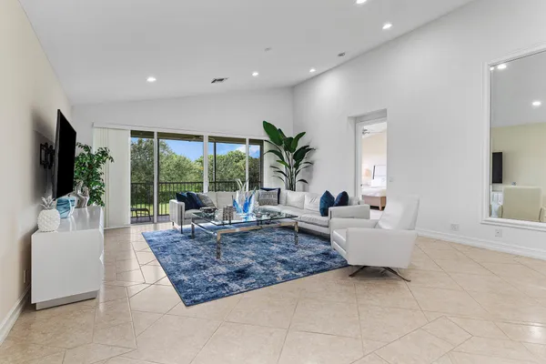 a living room with fireplace furniture flat screen tv and a large window