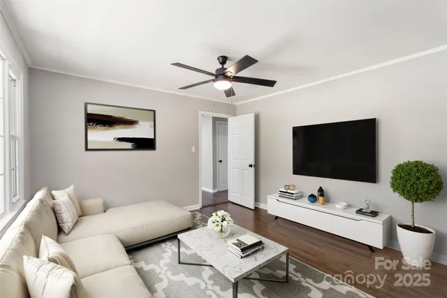 a view of a room with wooden floor and a ceiling fan