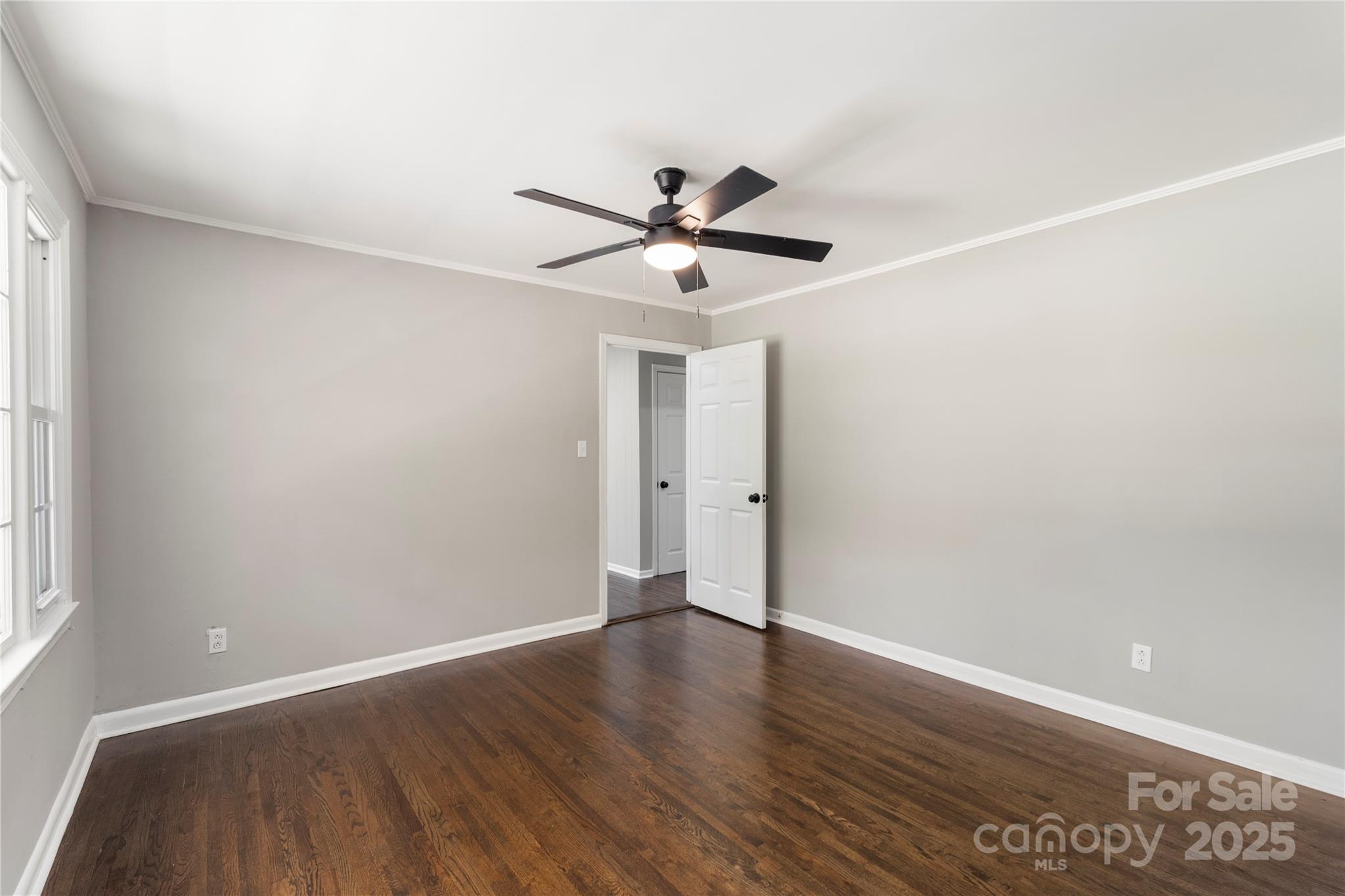 1428 Boxwood Avenue Lancaster, SC 29720 - Photo 12 of 44 a view of a room with wooden floor and a ceiling fan