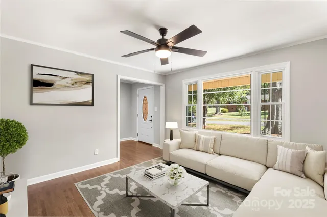 a view of a livingroom with a window and a ceiling fan